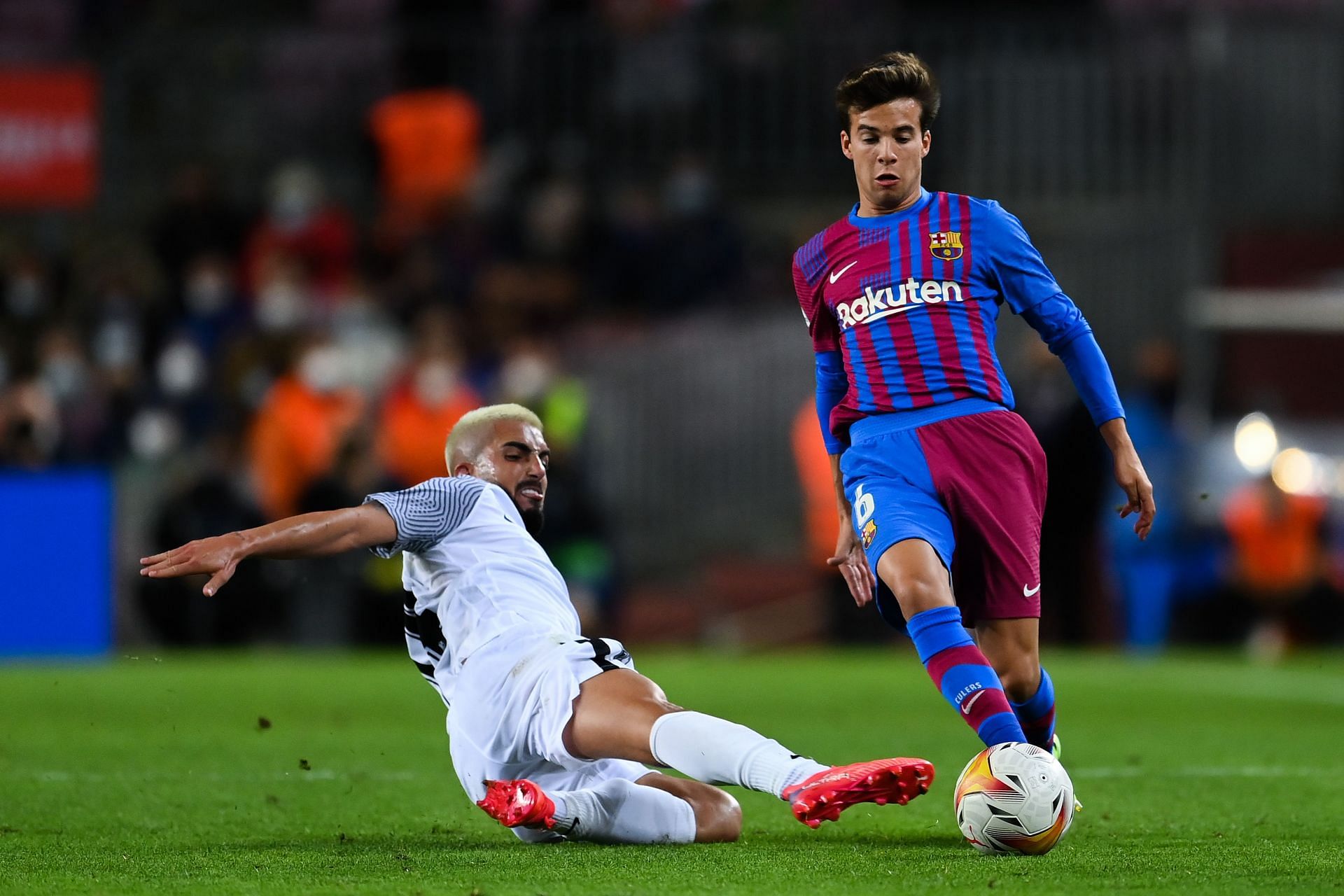 FC Barcelona's Riqui Puig evades a challenge